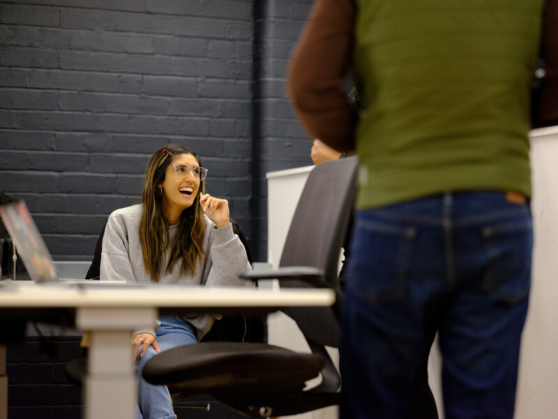 Farrah sat down at a desk smiling